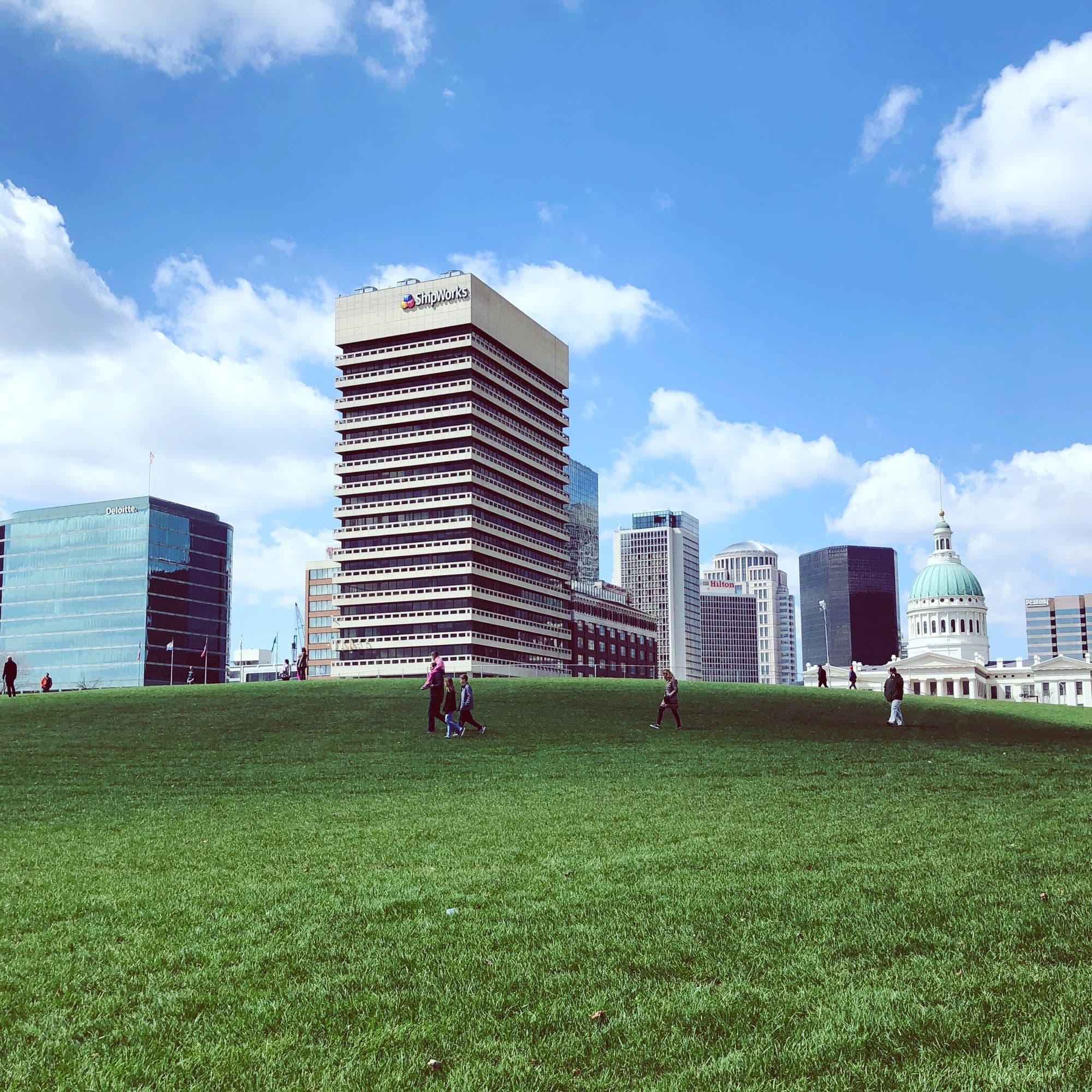 Downtown St. Louis skyline and the Old Courthouse dome seen across a green park