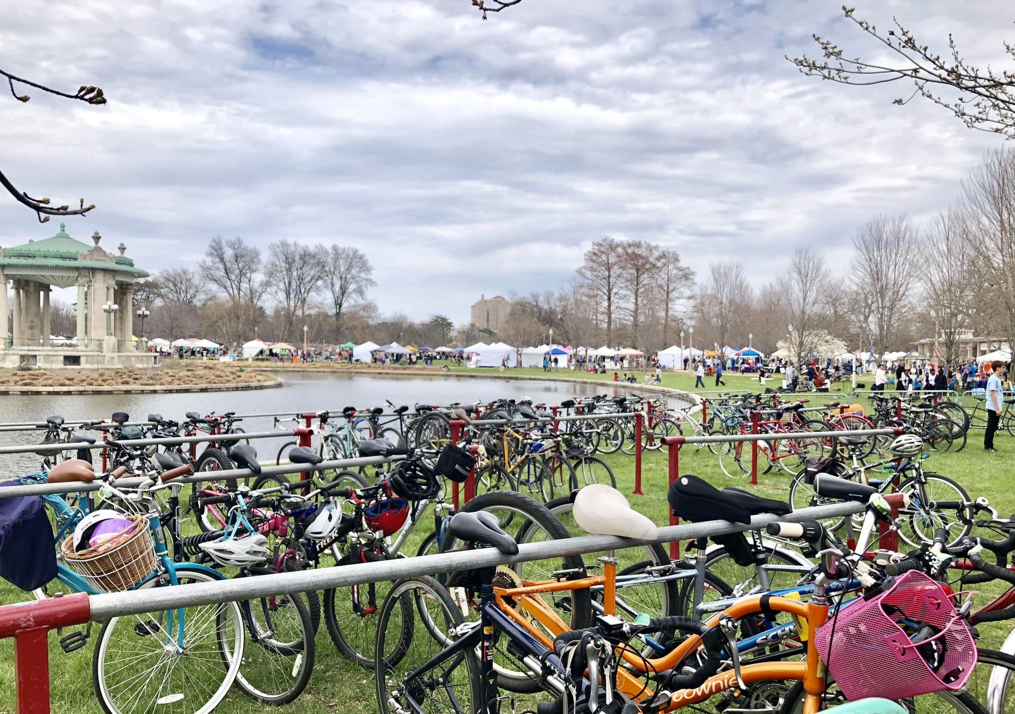 Bicycles parked at racks beside the lake in Forest Park during a community event